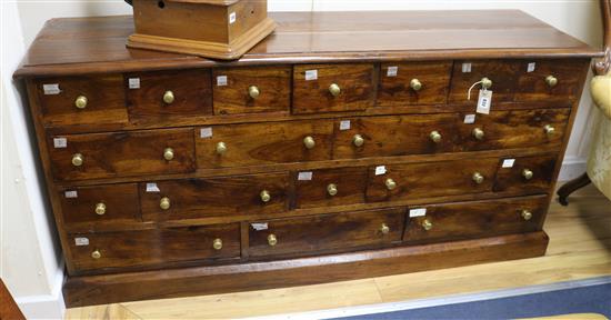A shop counter of nineteen drawers W.162cm